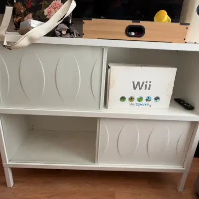White sliding door media console, Nintendo Wii console in box