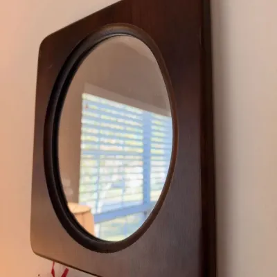 Round wall mirror in square dark wood frame