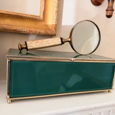 Green glass and brass jewelry box with magnifying glass