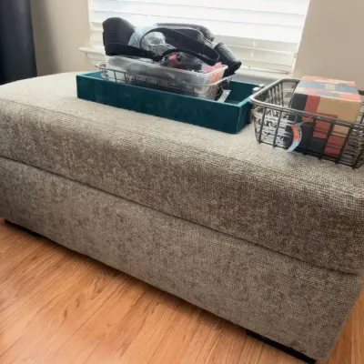 Gray upholstered ottoman, teal tray, wire basket