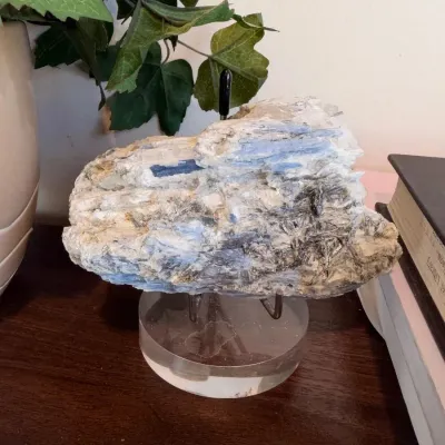 Blue and white mineral specimen on clear acrylic stand