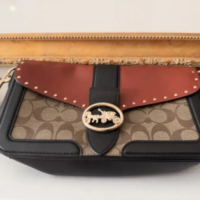 Coach signature canvas shoulder bag, studded leather flap, horse and carriage turnlock