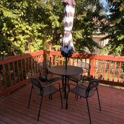 Outdoor patio dining set, round table, chairs, striped umbrella