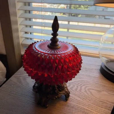 Ruby red glass lidded jar on ornate metal base