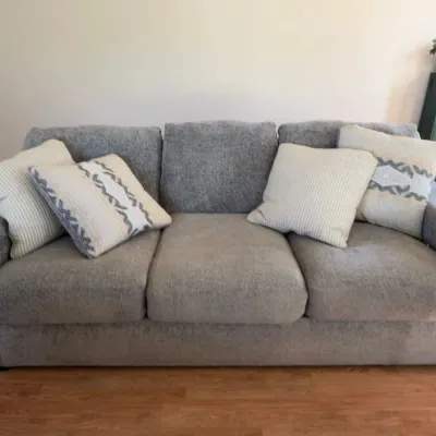 Gray three-cushion upholstered sofa, front view
