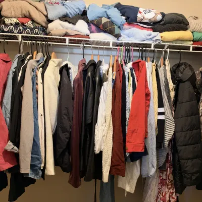 Closet of clothing, leather jackets, coats, sweaters