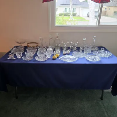 Crystal and decorative glassware assortment with decanters, stemware, bowls, plates and serving pieces.