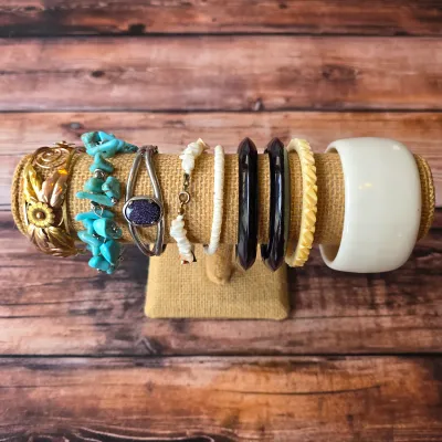 Vintage costume bracelets and bangles in assorted colors, textures and decorative styles.