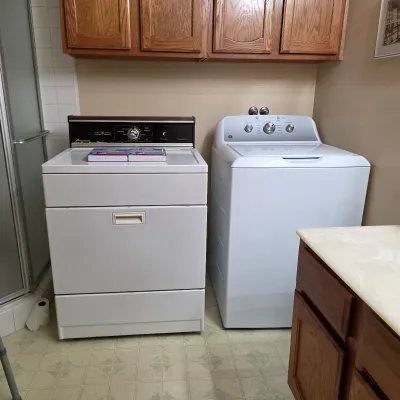 Top-loading washing machine and gas clothes dryer available at the Fullerton estate sale.