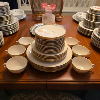 Lenox Wheat china with gold wheat decoration and gold rims, including plates, bowls, cups and saucers.