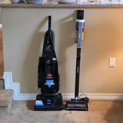 Upright carpet cleaner and stick vacuum cleaner among the household cleaning equipment.