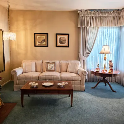 Traditional striped sofa, wood coffee table, pedestal side table and decorative lighting
