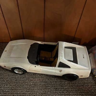 Sale Photo Thumbnail #97: Vintage Barbie Ferrari 328 GTS convertible toy car in white, showing some wear and missing its windshield.
