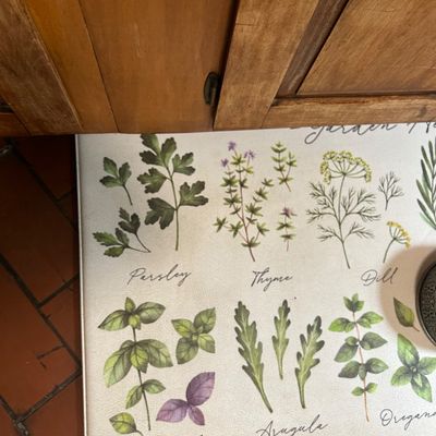 Sale Photo Thumbnail #14: Cushioned kitchen floor mat featuring botanical illustrations of herbs like parsley, thyme, dill, basil, and arugula with cursive labels.