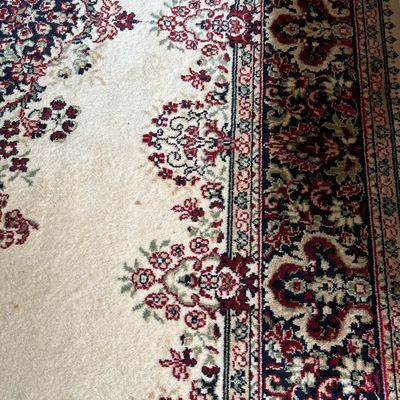 Sale Photo Thumbnail #138: Traditional Persian-style area rug featuring a cream field with red, navy blue, and sage green floral motifs and borders.