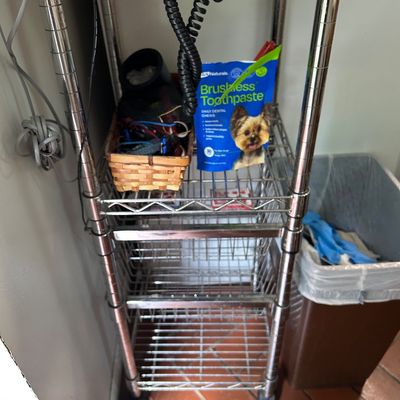 Sale Photo Thumbnail #8: Four-tier chrome wire rolling cart with a wooden top shelf, showing some wear from use.