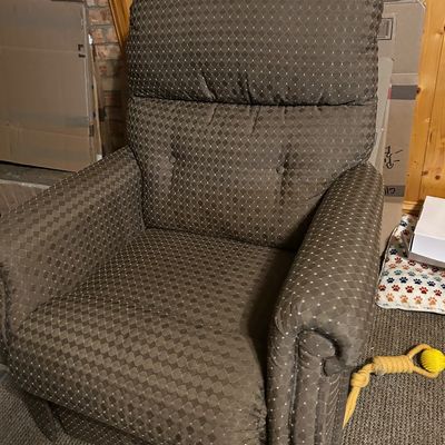 Sale Photo Thumbnail #68: Upholstered recliner chair featuring a brown and beige diamond pattern, rolled arms, and a tufted backrest.
