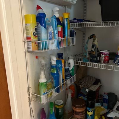 Sale Photo Thumbnail #101: Assorted household cleaning supplies, pet items, and pantry goods organized on wire shelving units.