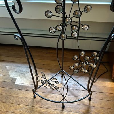 Sale Photo Thumbnail #141: Wrought iron accent table base featuring decorative metal starbursts inset with faceted glass crystals.