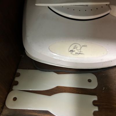 Sale Photo Thumbnail #13: George Foreman grill by Salton, featuring a white exterior, original manual, and two plastic cleaning spatulas.