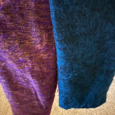 Sale Photo Thumbnail #73: Two textured woven scarves or fabric lengths, one in a shimmering purple and copper blend and the other in a deep teal blue.