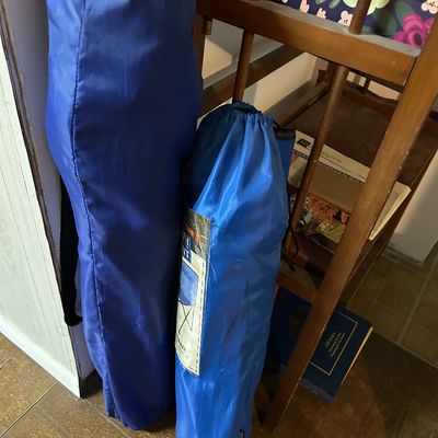 Sale Photo Thumbnail #63: Two blue folding camp chairs in their original carrying bags, leaning against a wooden shelf.