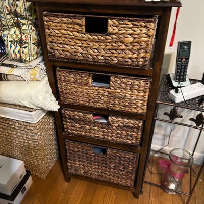 Sale Photo Thumbnail #115: Four-tier dark wood storage tower featuring woven water hyacinth basket drawers with integrated handles.