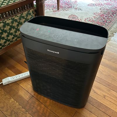 Sale Photo Thumbnail #99: Honeywell HEPA air purifier in black, featuring a digital control panel on top, shown on a hardwood floor.