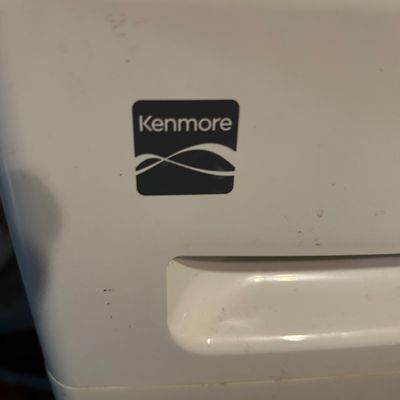 Sale Photo Thumbnail #62: Kenmore white appliance, showing the brand logo and integrated handle, with some light surface wear.