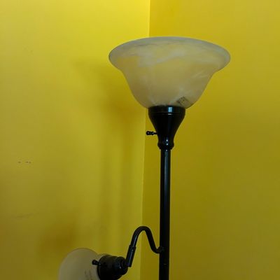 Sale Photo Thumbnail #118: Modern black metal torchiere floor lamp with an adjustable reading light and frosted glass shades.