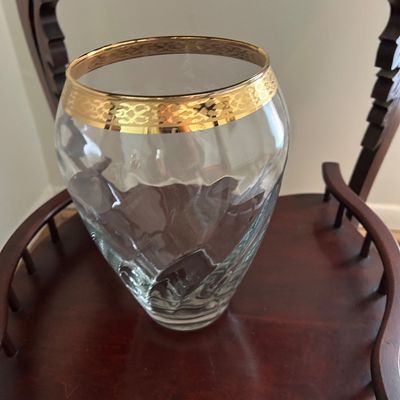Sale Photo Thumbnail #129: Vintage clear glass vase featuring a wide gold-gilt rim with an etched pattern, displayed on a wooden chair.