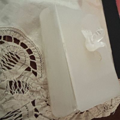 Sale Photo Thumbnail #23: Vintage frosted glass trinket box featuring a molded dove finial on the lid, displayed on a white lace doily.
