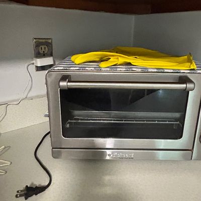 Sale Photo Thumbnail #33: Cuisinart stainless steel convection toaster oven broiler, showing light wear from use.