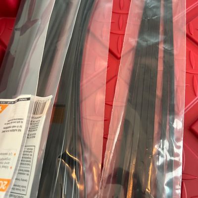 Sale Photo Thumbnail #128: Two packages of HDX 14-inch black cable ties, 20-pack, resting on a red textured surface.