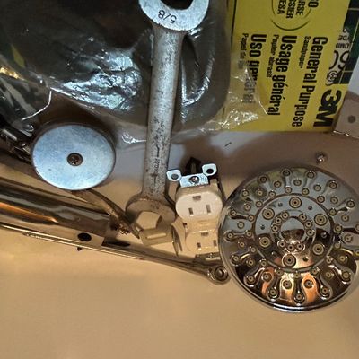 Sale Photo Thumbnail #47: Assorted household hardware and tools, including a chrome shower head, a 5/8-inch wrench, a duplex electrical outlet, and 3M sandpaper.
