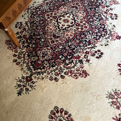 Sale Photo Thumbnail #137: Traditional Persian-style area rug featuring a central medallion in red, navy, and cream tones on a light beige field.