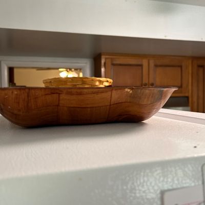 Sale Photo Thumbnail #34: Mid-century woven wood serving bowl shown sitting atop a white appliance, with a smaller woven basket visible inside.