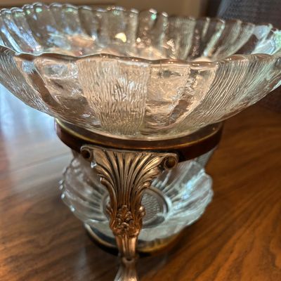 Sale Photo Thumbnail #147: Vintage textured clear glass centerpiece bowl resting on an ornate silver-plated and wood pedestal stand.
