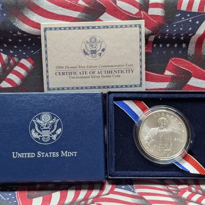 Sale Photo Thumbnail #144: 2004-P Thomas Alva Edison 125th Anniversary of The Light Bulb Commemorative 90% Silver Dollar - COA & Original Packaging