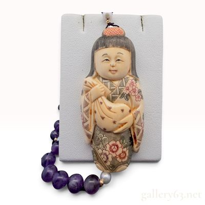 A 14K Yellow Gold Amethyst Pearl and Carved Bone Figural Necklace