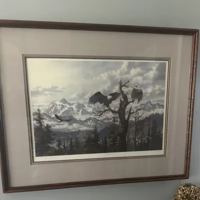 Sale Photo Thumbnail #29: Framed and matted wildlife art print depicting bald eagles in a mountainous landscape, housed in a dark wood frame.