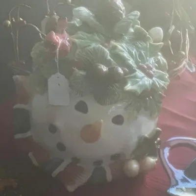 Sale Photo Thumbnail #50: Ceramic snowman cookie jar featuring a lid adorned with holly leaves, pinecones, and a red cardinal.