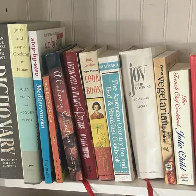 Sale Photo Thumbnail #38: Collection of vintage cookbooks and reference books on a shelf, including titles by Julia Child, Irma S. Rombauer, and Betty Crocker.