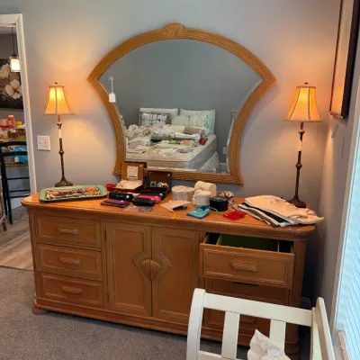 Sale Photo Thumbnail #97: Light oak dresser with a matching fan-shaped mirror featuring a carved shell motif, flanked by a pair of slender table lamps. Made by Bernhardt.