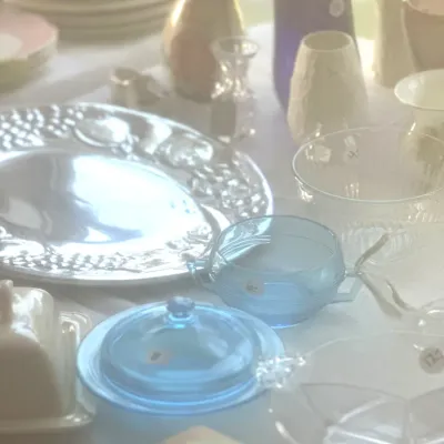 Sale Photo Thumbnail #105: Assorted vintage glassware and tableware, including a blue depression glass sugar bowl and butter dish, a silver-plated serving platter, and various ceramic vases.