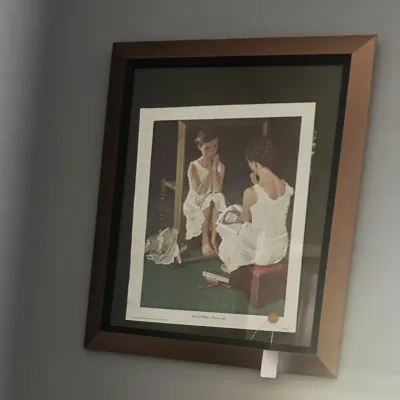 Sale Photo Thumbnail #30: Framed Norman Rockwell print titled "Girl at Mirror," professionally matted in a dark frame with a bronze-tone outer border.