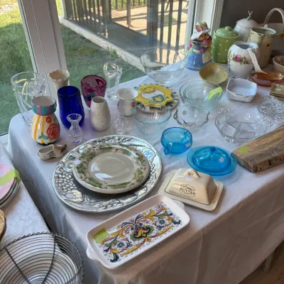 Sale Photo Thumbnail #109: Assorted vintage and contemporary kitchenware and decorative items, featuring a hand-painted Italian-style serving tray, a ceramic butter dish, colorful glass vases, and various serving bowls.