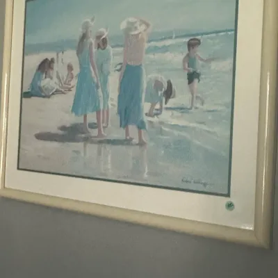 Sale Photo Thumbnail #25: Framed impressionistic beach scene print by Robert Laessig, featuring figures in blue and white attire on a sandy shore, housed in a light-colored frame.