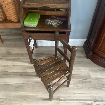 Sale Photo Thumbnail #3: Vintage child's roll-top desk in dark-stained oak, paired with a matching wooden slat-seat chair.