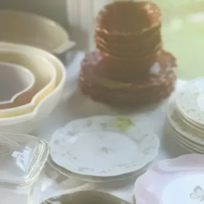 Sale Photo Thumbnail #107: Assorted vintage tableware, including a stack of brown ceramic plates and bowls, white and pink patterned plates, and nesting mixing bowls.